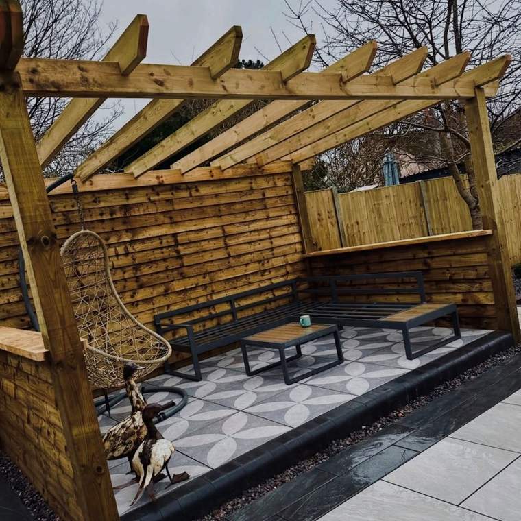 Timber pergola over a patterned porcelain seating area with a hanging chair