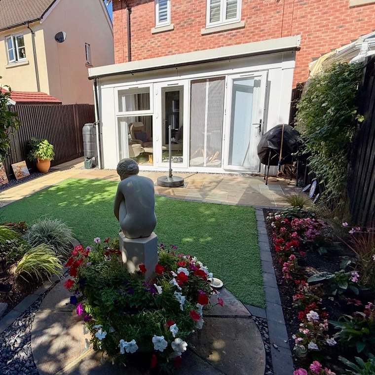 Single-storey garden room extension with French doors on a brick house
