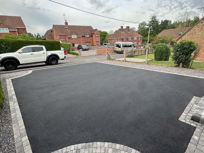 Tarmac driveway with a silver-grey block paving border