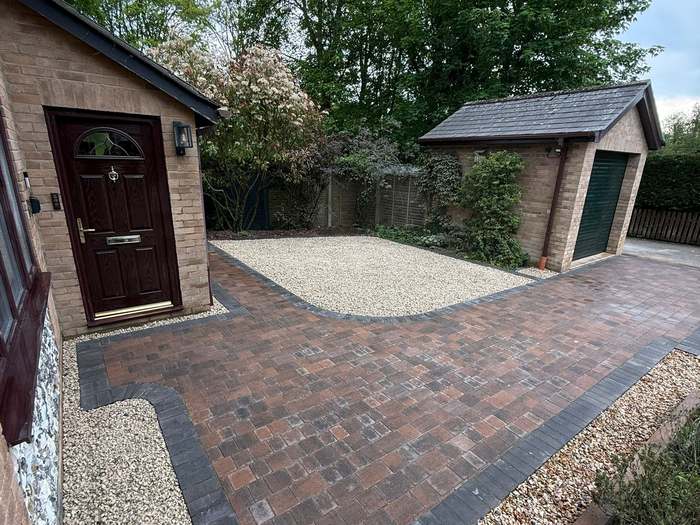 Block paving driveway with contrasting border and gravel edges
