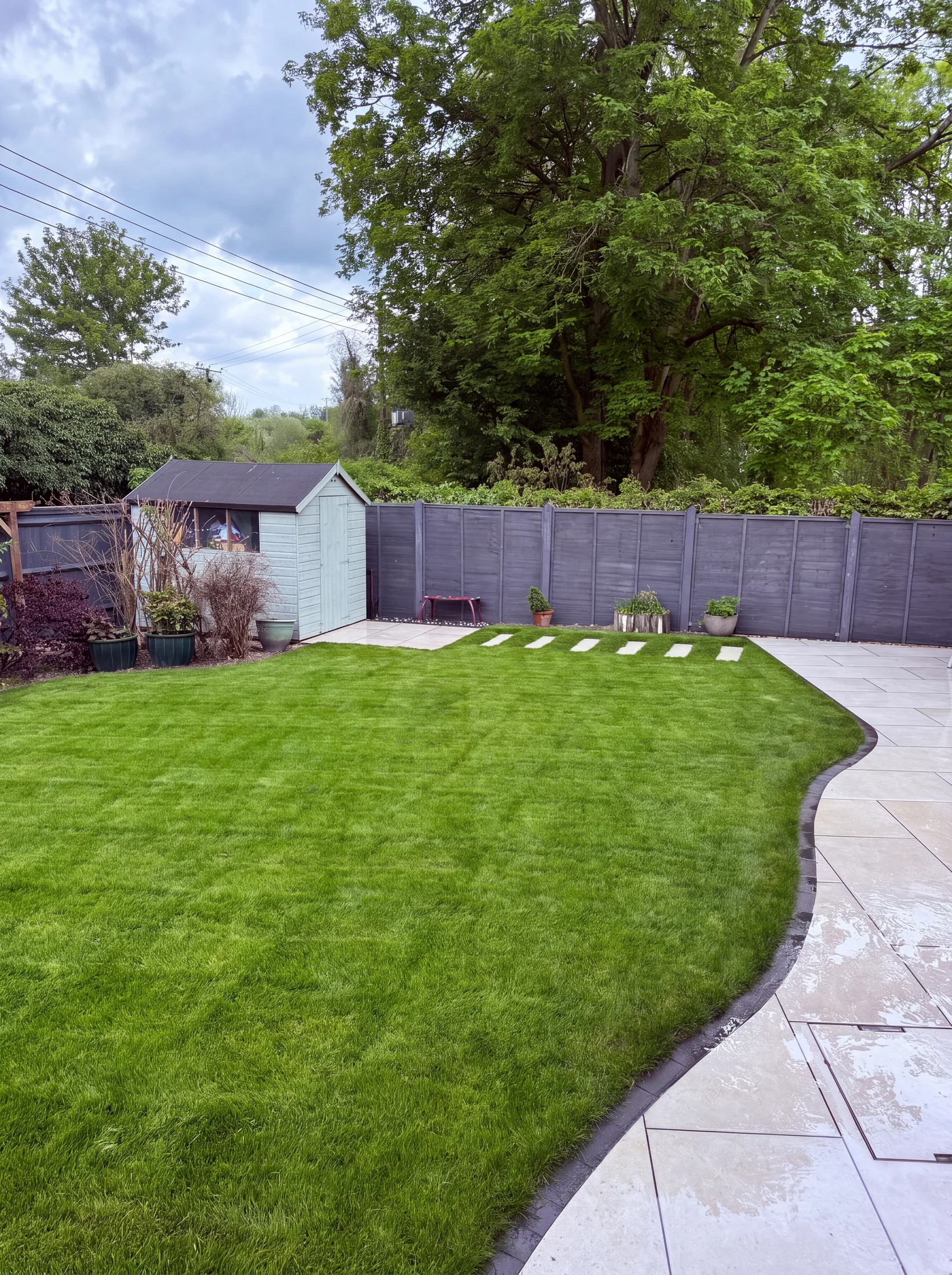 The same garden after: new curved lawn and sandstone paving