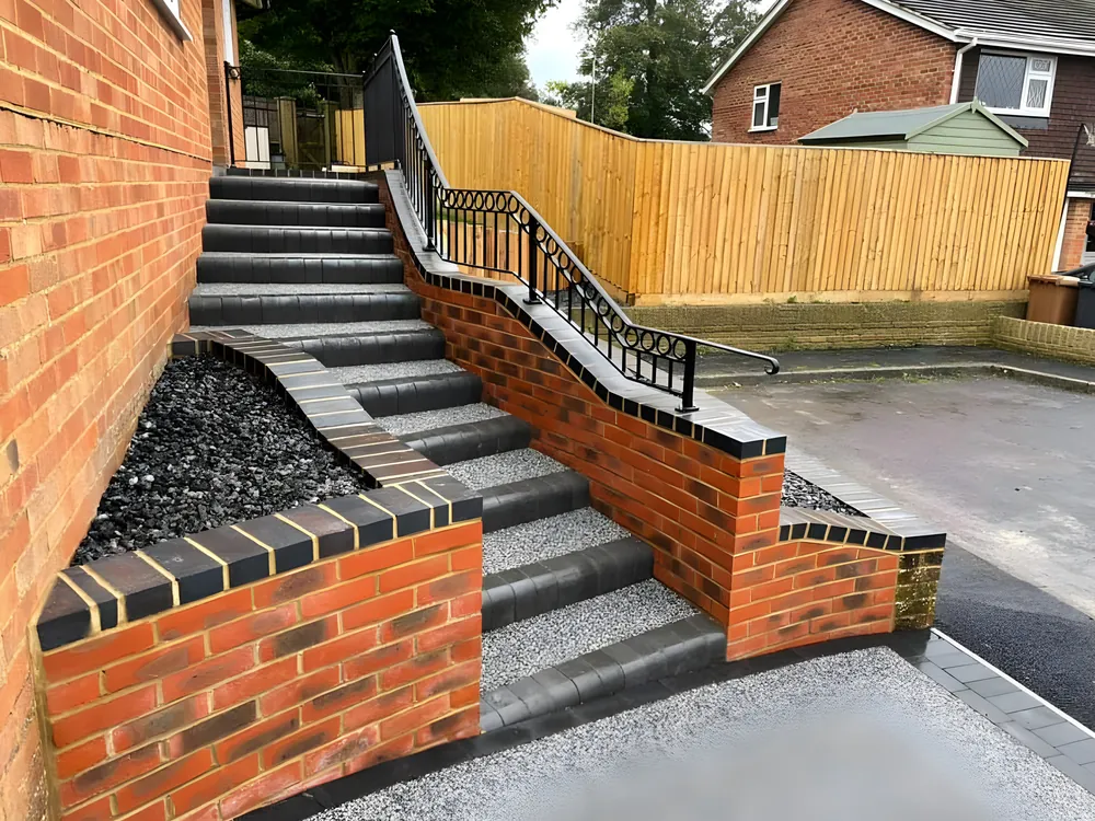 Brick retaining walls with granite steps and black railings