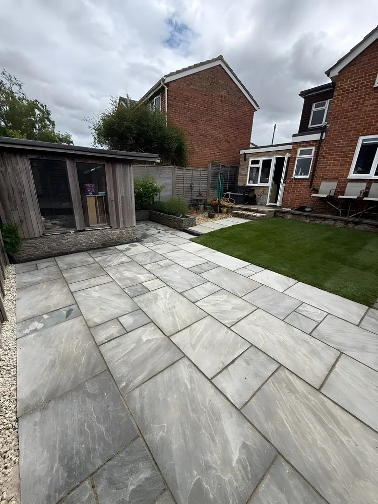 Porcelain path leading past a timber garden room to the lawn