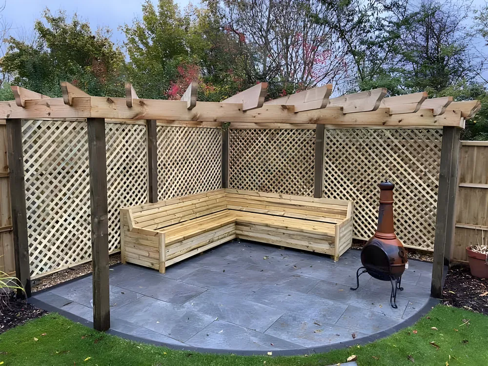 Lattice sided pergola over a curved slate patio with built in bench seating