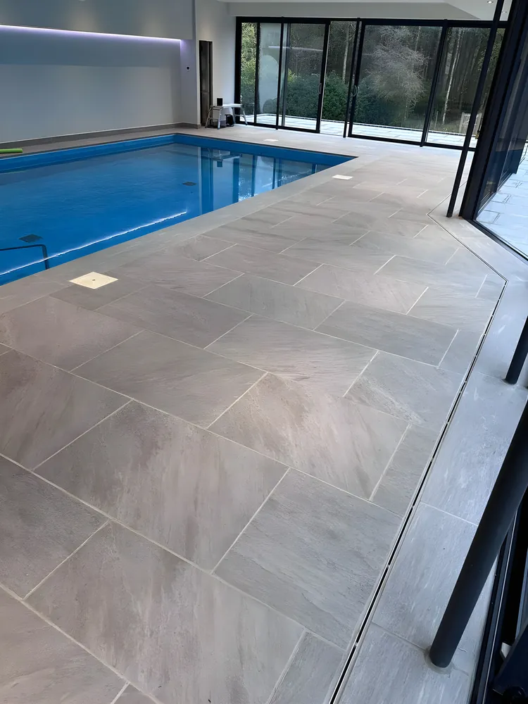 Indoor pool with large format porcelain paving and glazed doors