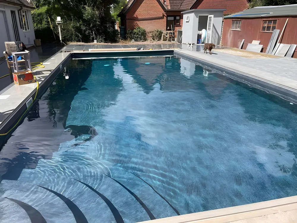 Swimming pool with a new natural stone surround