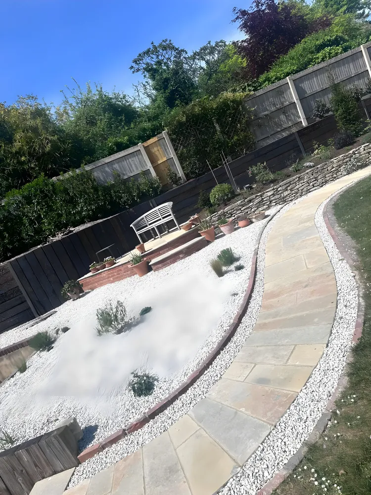 Sweeping sandstone path through a gravel garden