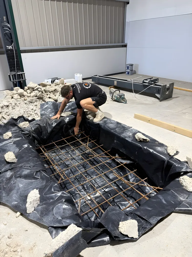 Steel reinforcement laid in a lined excavation ready for concrete