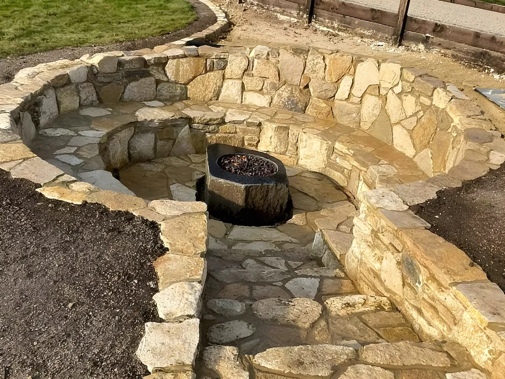 Sunken natural stone fire pit seating area