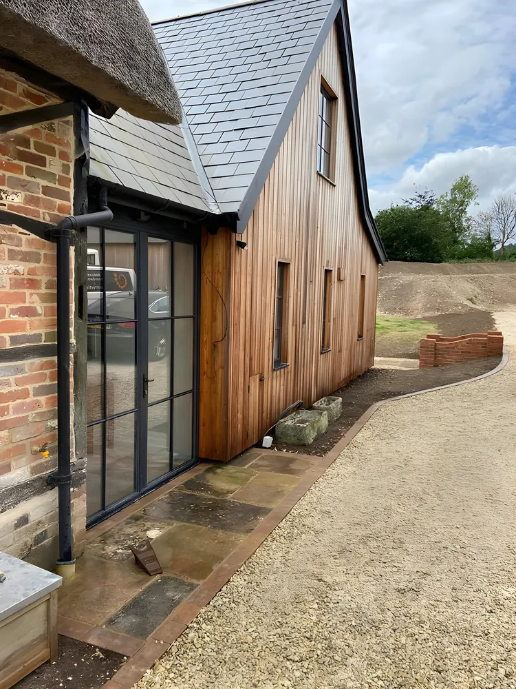 Timber clad extension with black framed glazing